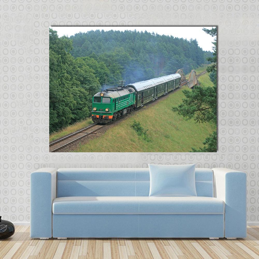 Passenger Train Through Polish Countryside Canvas Wall Art in gray, brown and green, single panel hung on a wall