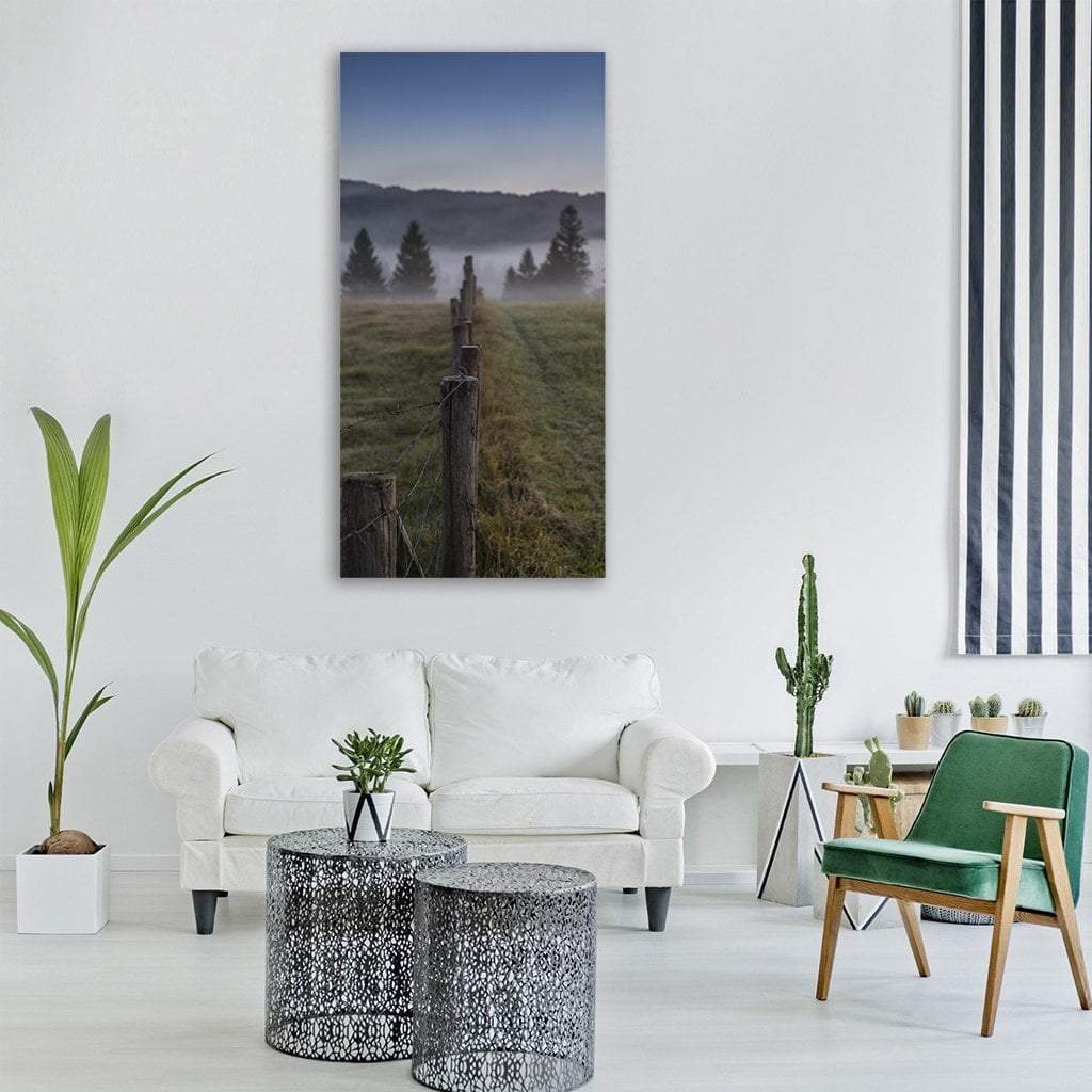 Pasture Fence in Morning Mist Vertical Canvas Wall Art in gray, green and blue, single vertical panel hung on a wall