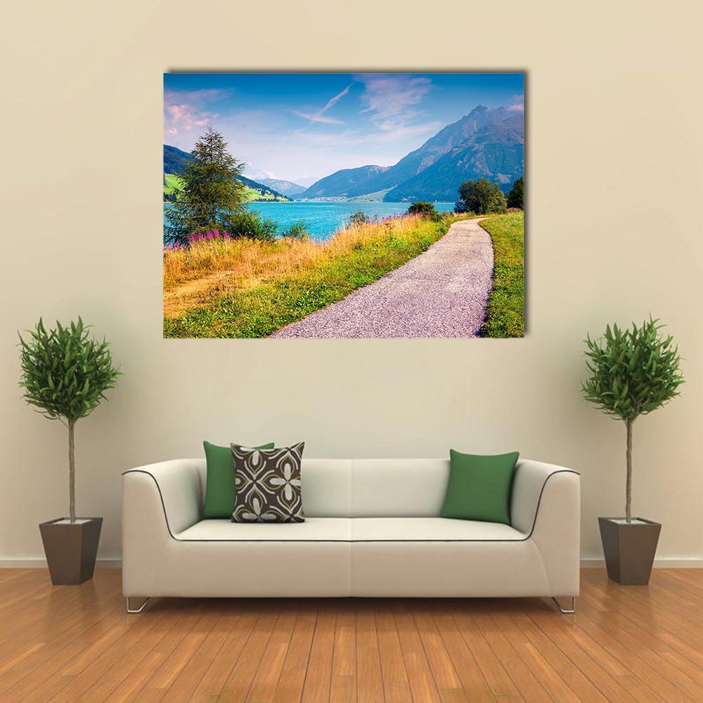 Gravel Path Beside Mountain Lake Canvas Wall Art in gray, green and blue, single panel hung on a wall