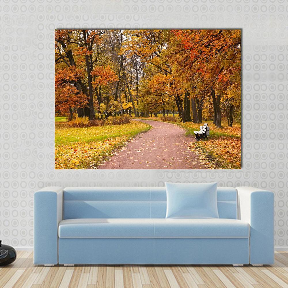 Pathway in Autumn Forest Canvas Wall Art in brown, orange and yellow, single panel hung on a wall