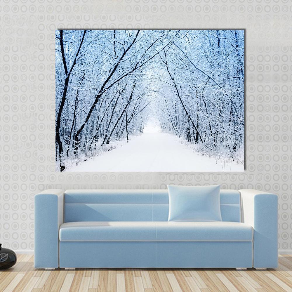 Pathway in Winter Canvas Wall Art in black, white and blue, single panel hung on a wall