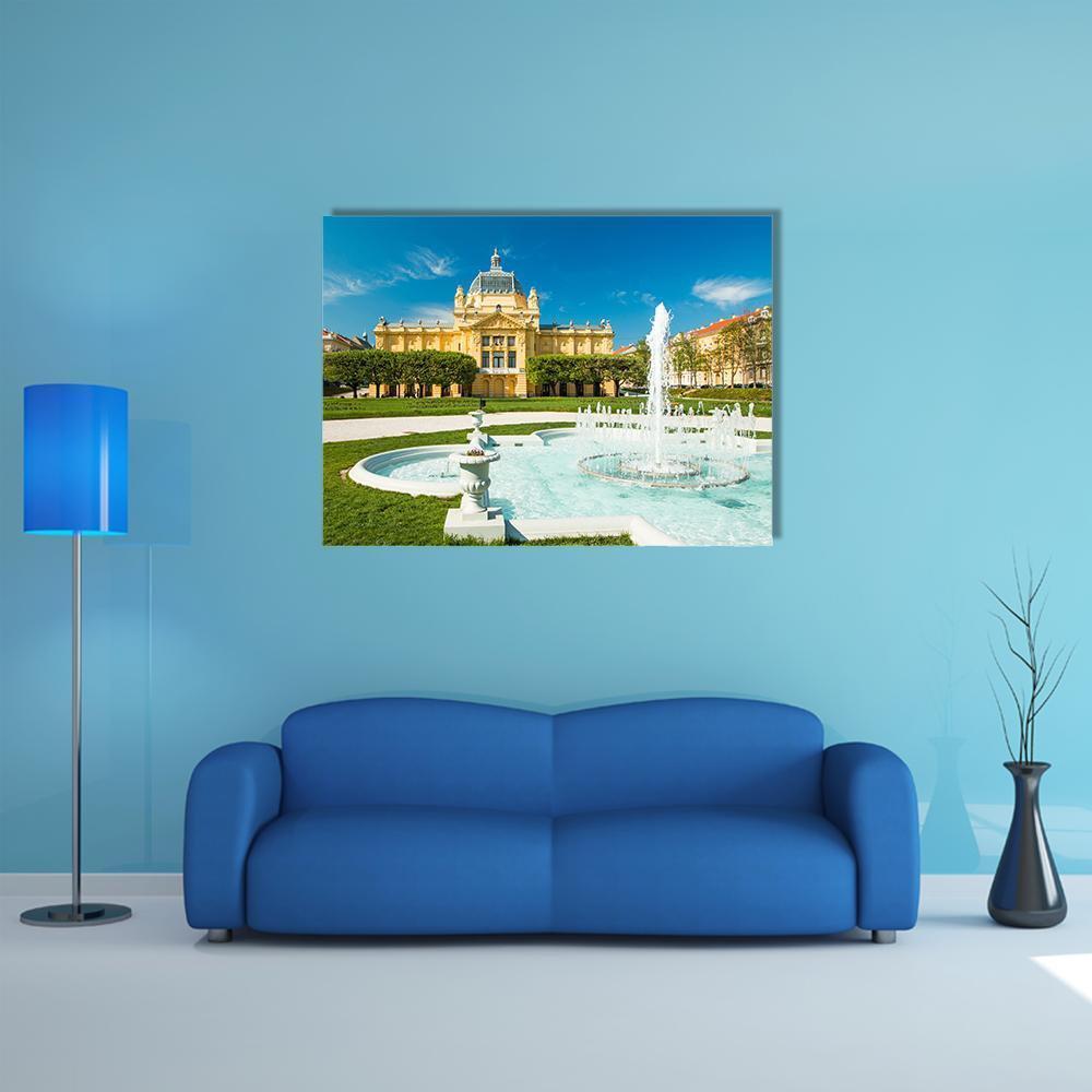 Pavilion and Fountain in Zagreb Canvas Wall Art in yellow, green and blue, single panel hung on a wall
