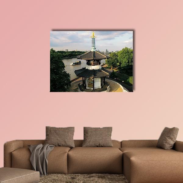 London Peace Pagoda Over River Canvas Wall Art in white, green and blue, single panel hung on a wall