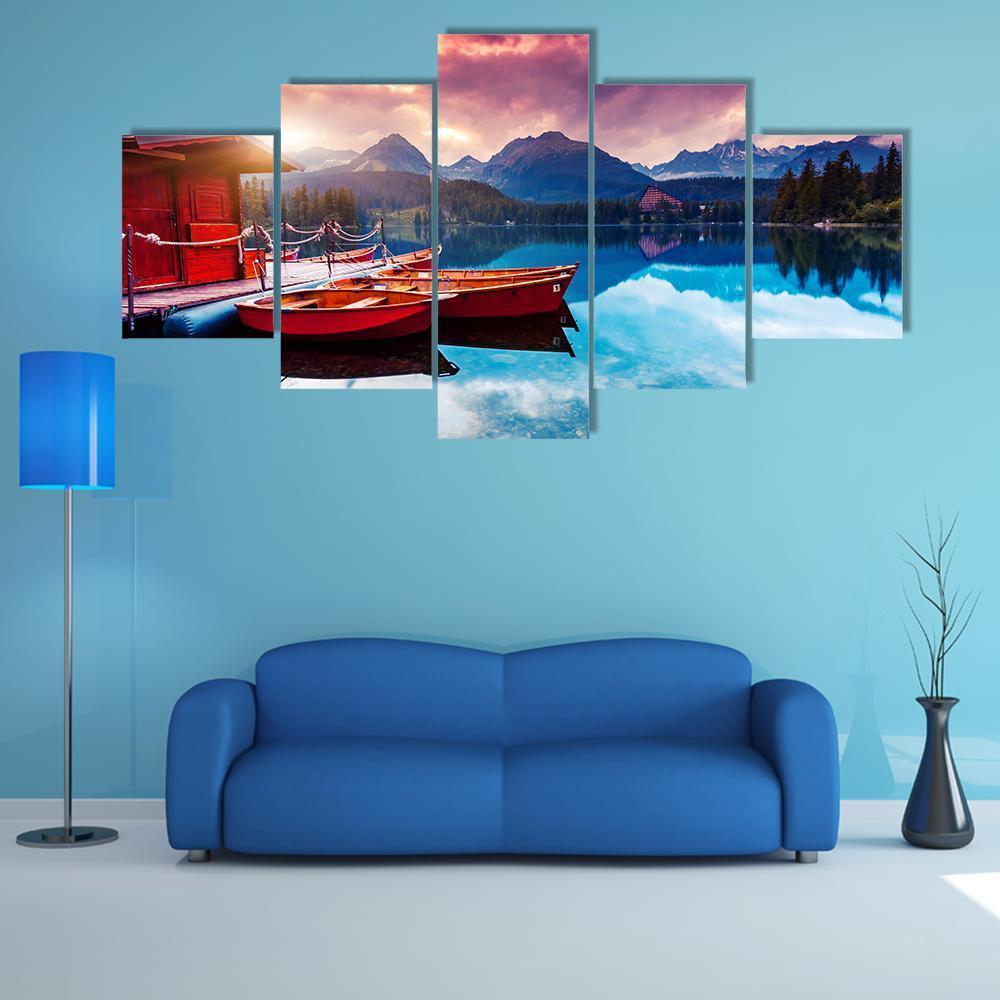 Two Red Boats on Mountain Lake at Sunset Canvas Wall Art in red, orange and blue, 5 panel Star layout hung on a wall