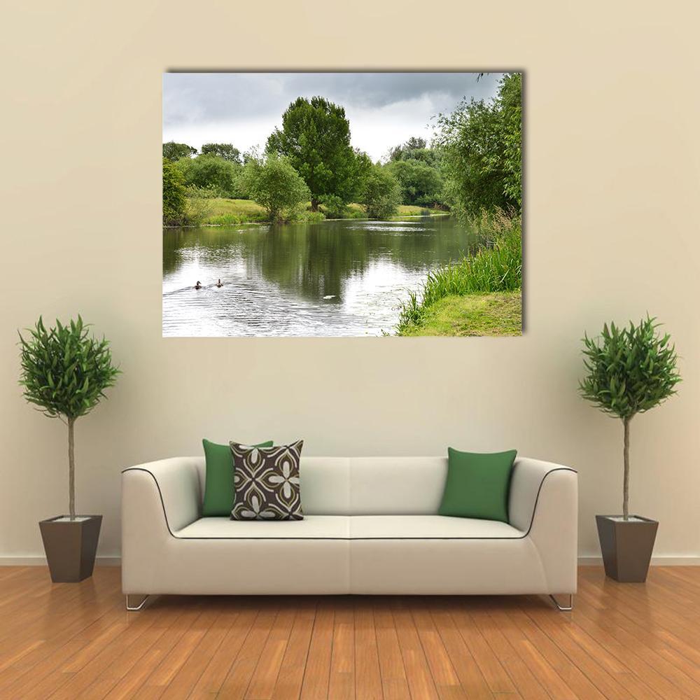 Tranquil River with Ducks and Reflections Canvas Wall Art in white, gray and green, single panel hung on a wall