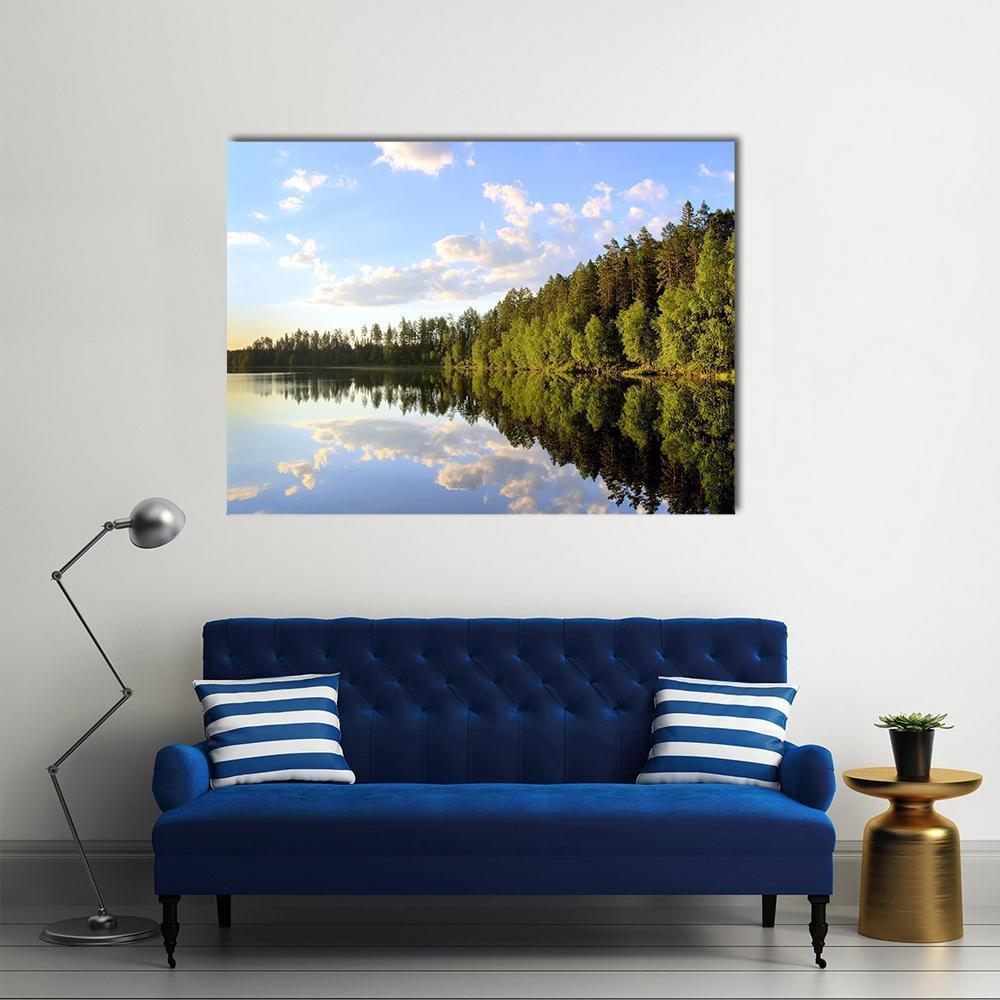 Lake Reflection with Forest and Cumulus Clouds Canvas Wall Art in white, green and blue, single panel hung on a wall