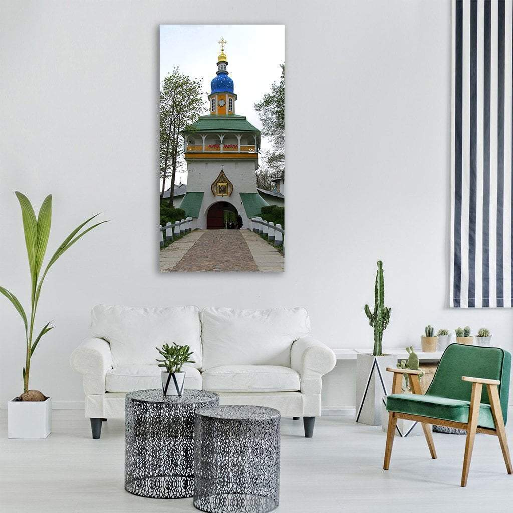 Pechory Monastery Church with Blue Dome Vertical Canvas Wall Art in white, green and blue, single vertical panel hung on a wall