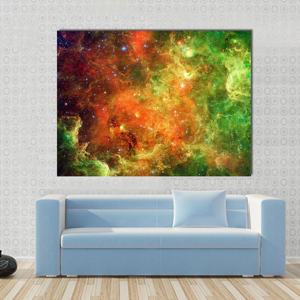 Pelican Nebula Canvas Wall Art in orange, yellow and green, single panel hung on a wall