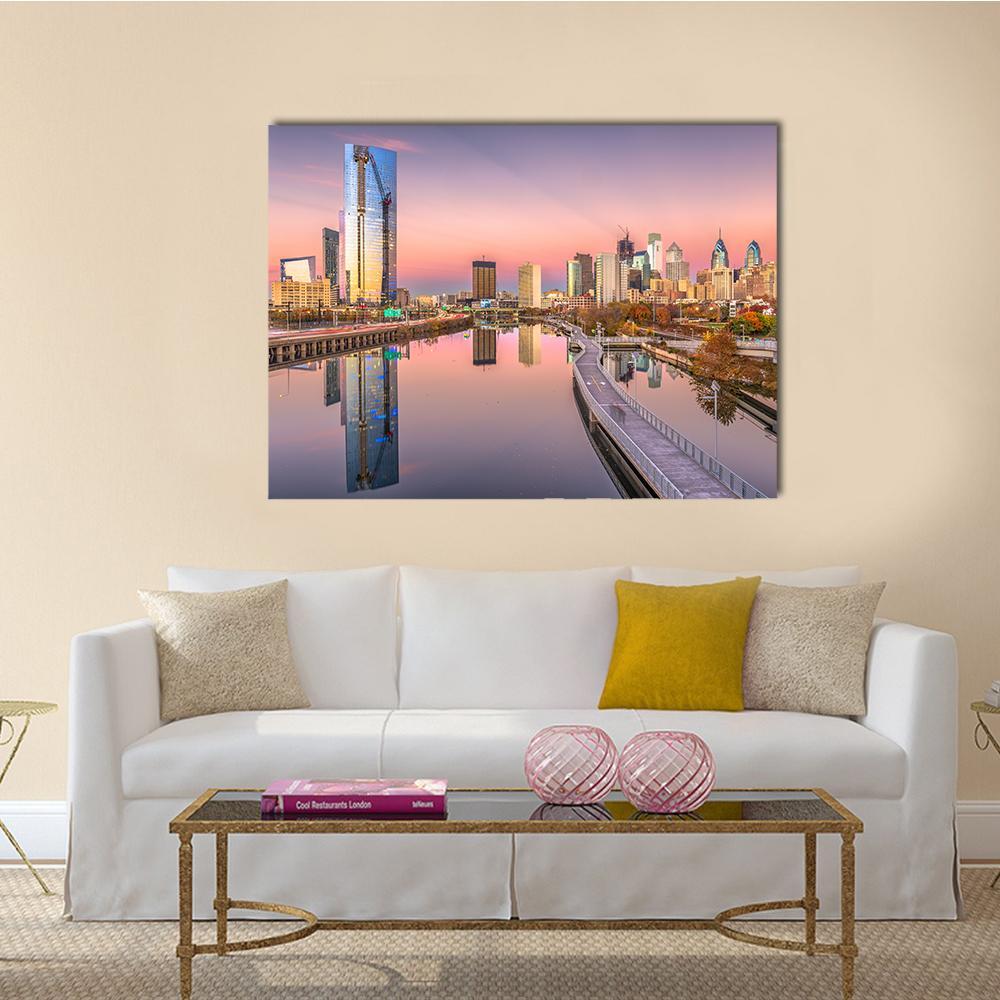 Sunset City Skyline with River Reflection Canvas Wall Art in blue, purple and pink, single panel hung on a wall