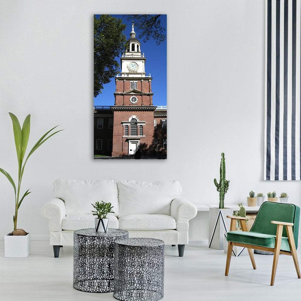 Independence Hall Red Brick Clock Tower, Pennsylvania Vertical Canvas Wall Art in brown, red and blue, single vertical panel hung on a wall
