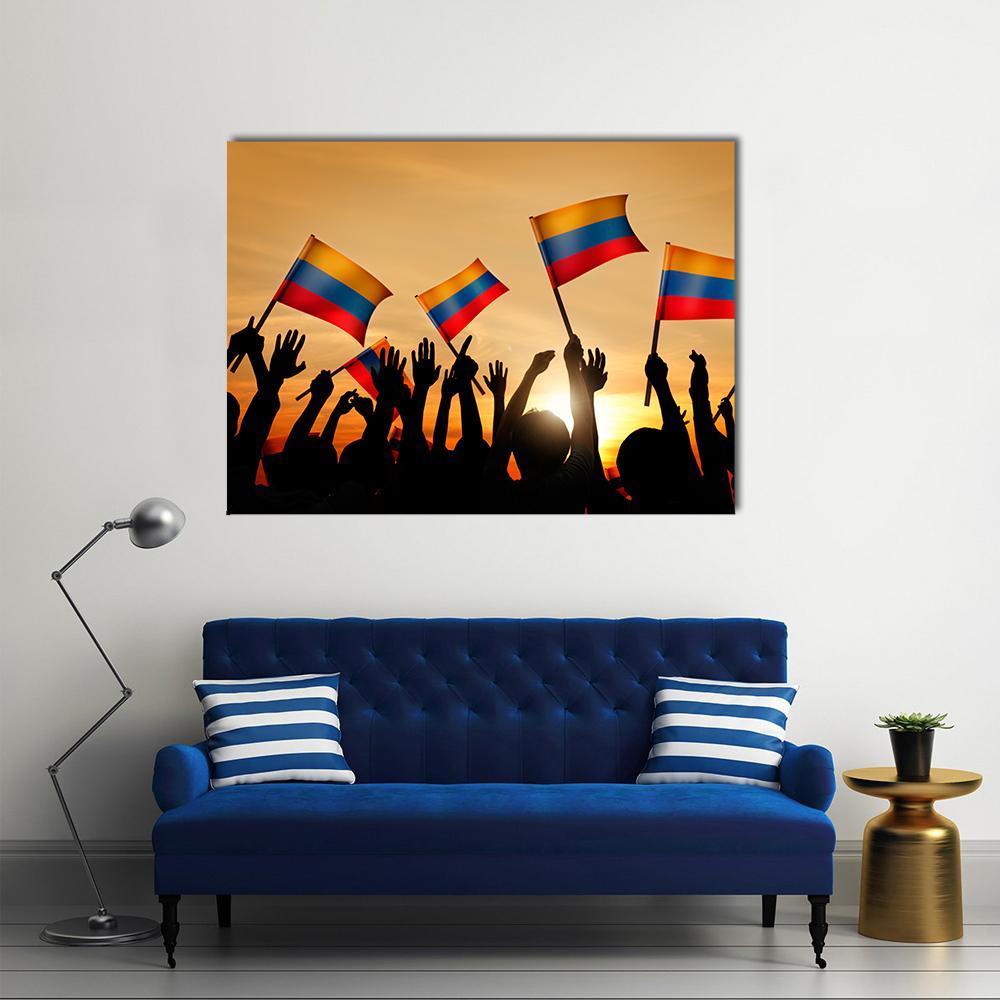 Crowd Holding Colombian Flags at Sunset Canvas Wall Art in black, orange and yellow, single panel hung on a wall