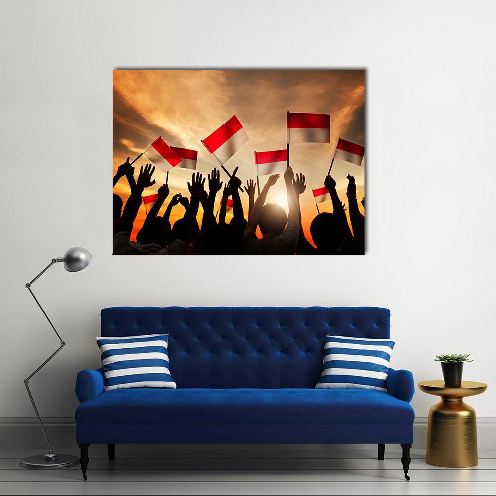 Indonesian Flags Over Silhouetted Crowd Canvas Wall Art in black, red and orange, single panel hung on a wall