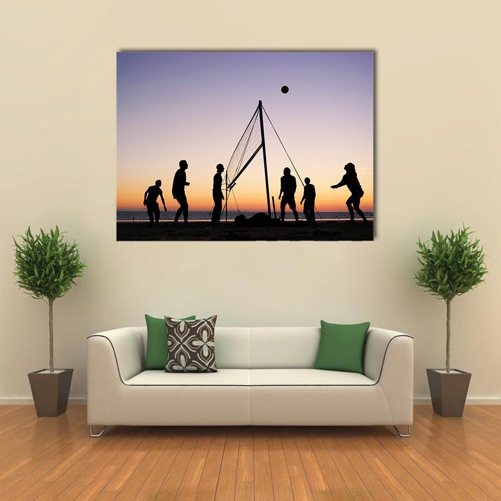 Sunset Beach Volleyball Silhouettes Canvas Wall Art in black, orange and purple, single panel hung on a wall