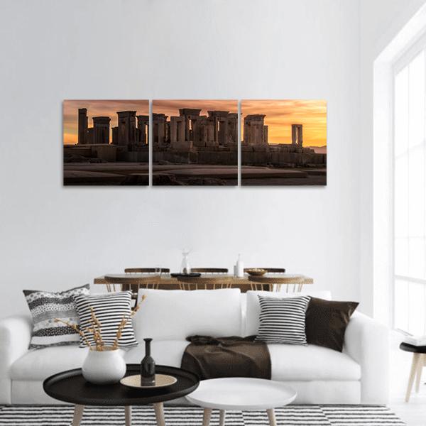 Persepolis Ruins at Golden Dusk Panoramic Canvas Wall Art in brown, gold and orange, hung on a wall