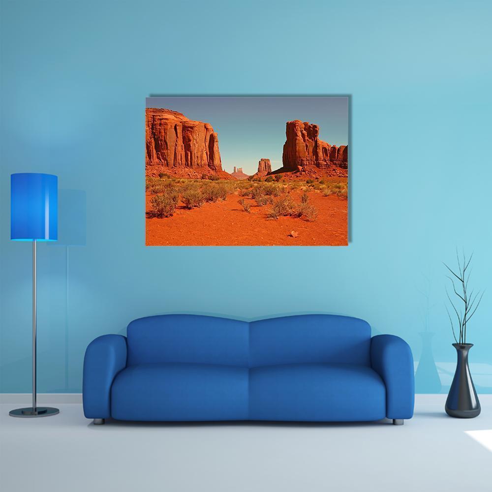 Monument Valley Perspective Canvas Wall Art in red, orange and blue, single panel hung on a wall