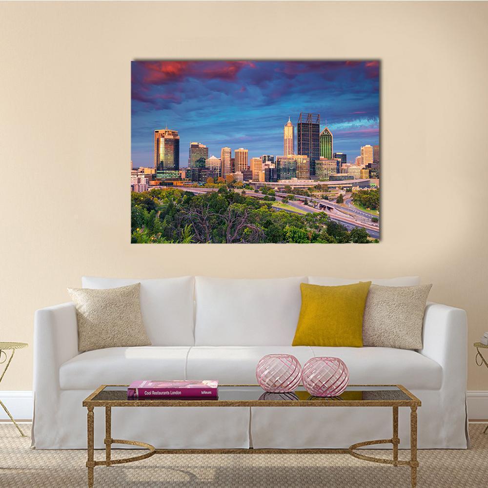 City Skyline at Sunset Canvas Wall Art in orange, yellow and blue, single panel hung on a wall