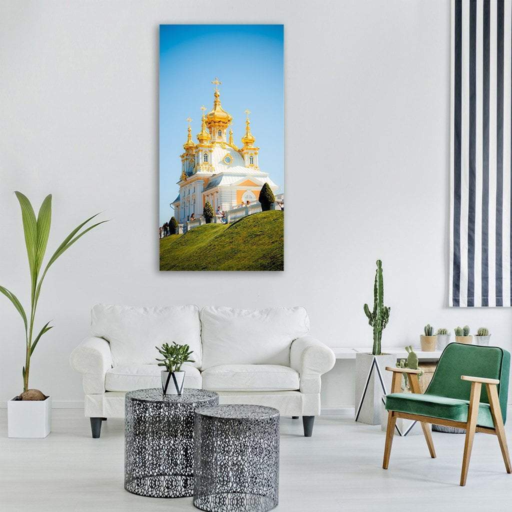 Orthodox Church with Golden Domes on Grassy Hill Vertical Canvas Wall Art in gold, green and blue, single vertical panel hung on a wall