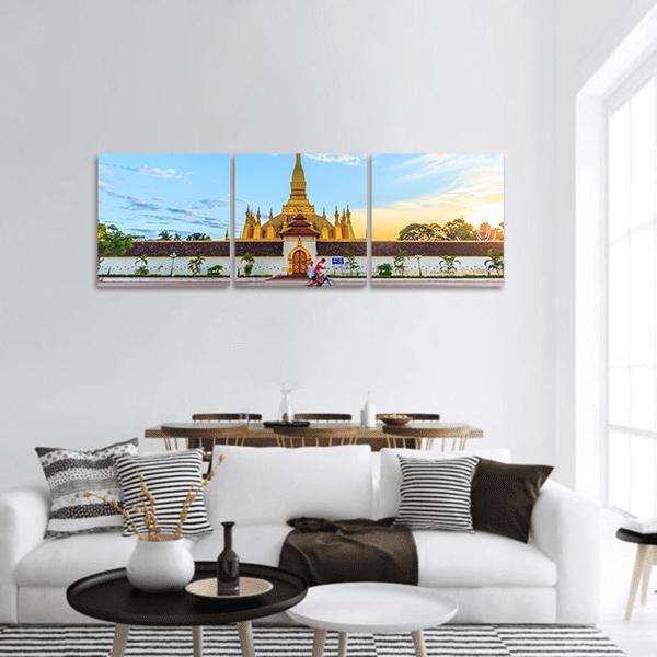 Pha That Luang Stupa, Vientiane Panoramic Canvas Wall Art in gold, yellow and blue, hung on a wall