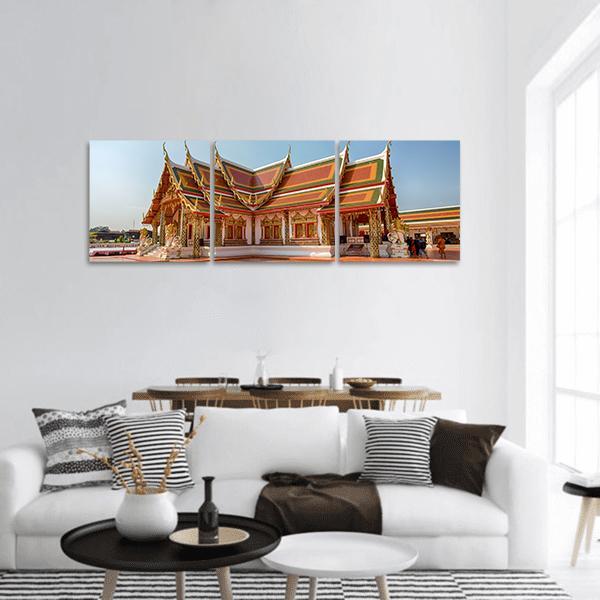 Phra That Choeng Chum Temple in Thailand Panoramic Canvas Wall Art in gold, red and blue, hung on a wall