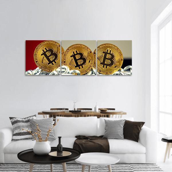 Three Golden Bitcoin Coins on Chains Panoramic Canvas Wall Art in black, gold and silver, hung on a wall