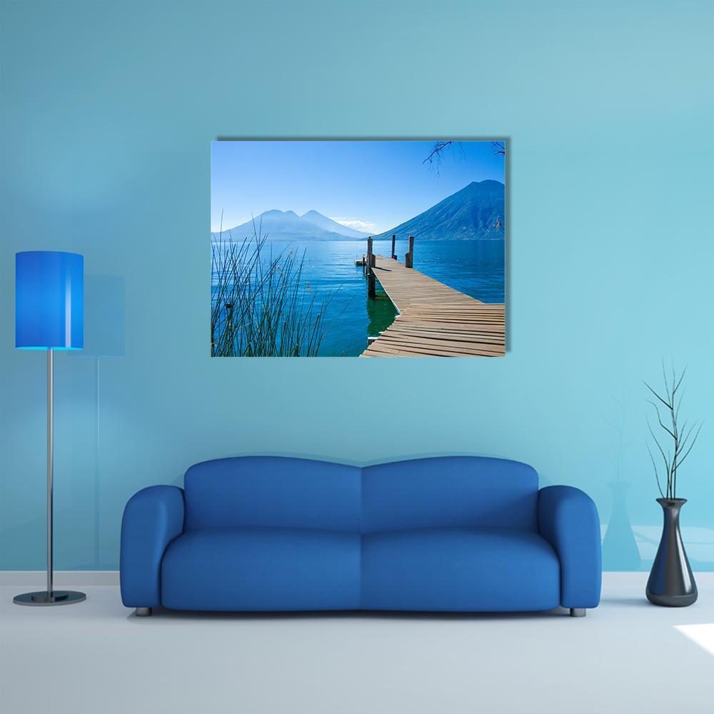 Wooden Dock at Mountain Lake Canvas Wall Art in brown and blue, single panel hung on a wall