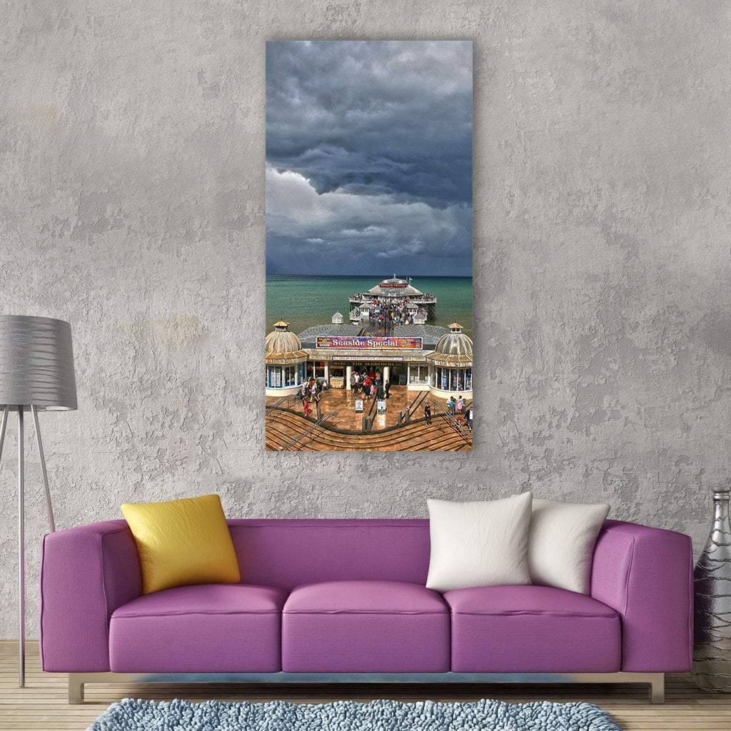 Crowded Seaside Pier on Overcast Summer Day Vertical Canvas Wall Art in gray, brown and blue, single vertical panel hung on a wall