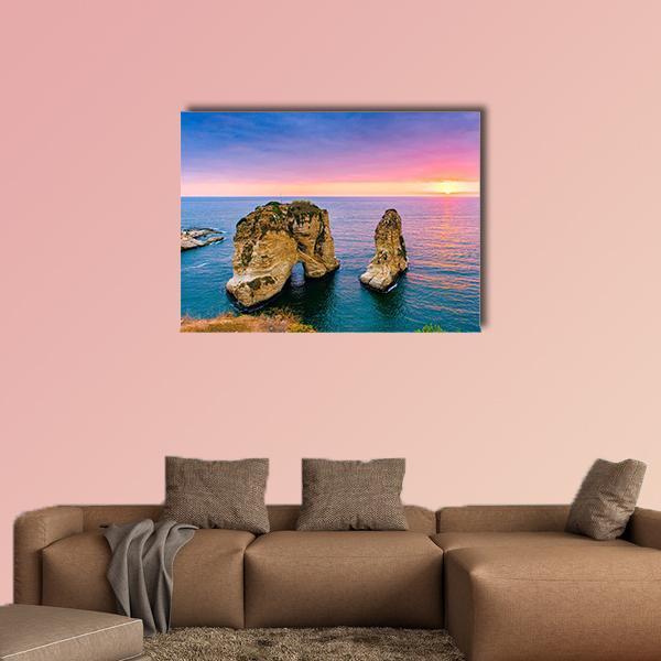 Pigeons on Coastal Rock at Sunset Canvas Wall Art in orange, blue and pink, single panel hung on a wall
