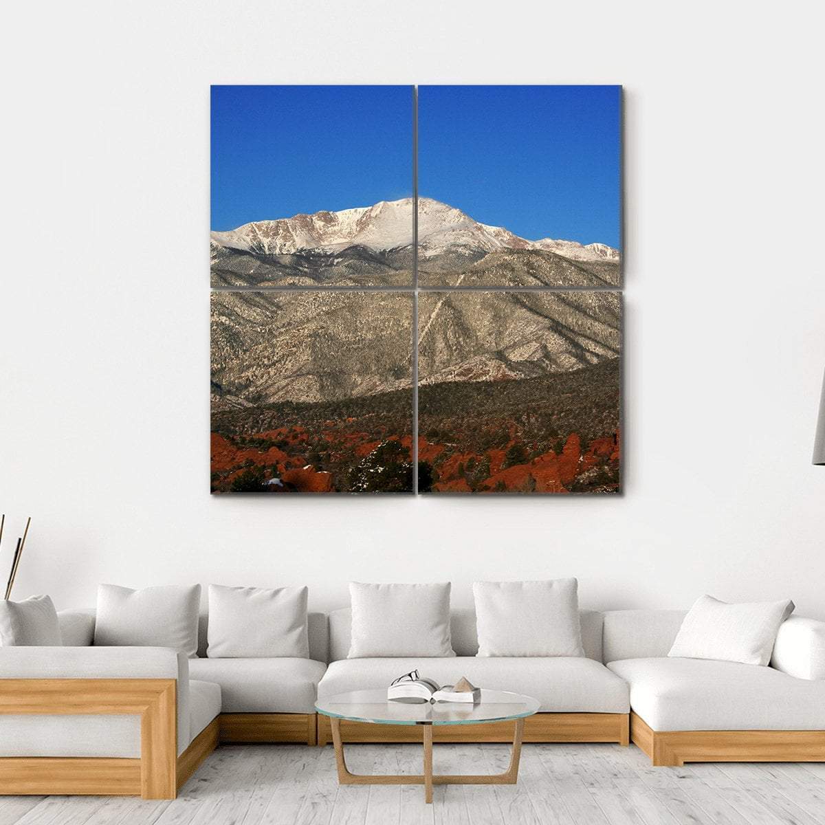Red Rocks with Snow-capped Mountain Peaks Canvas Wall Art in brown, red and blue, hung on a wall
