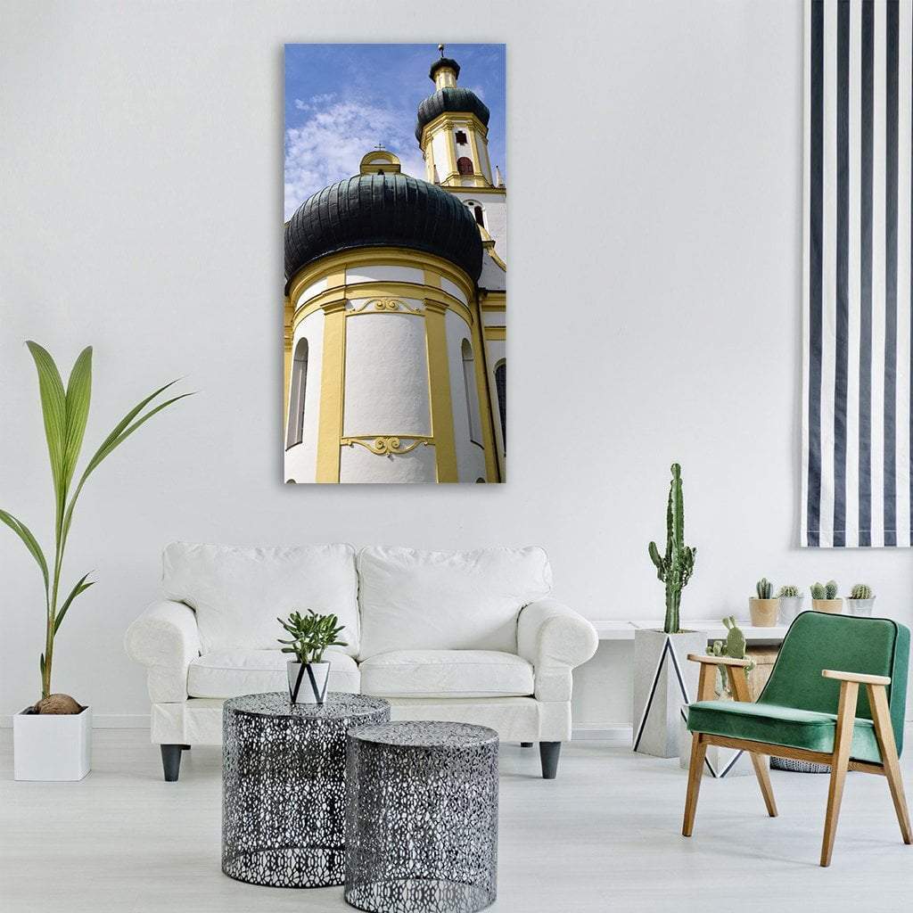 Baroque Church Tower with Black Onion Dome Vertical Canvas Wall Art in white, yellow and blue, single vertical panel hung on a wall