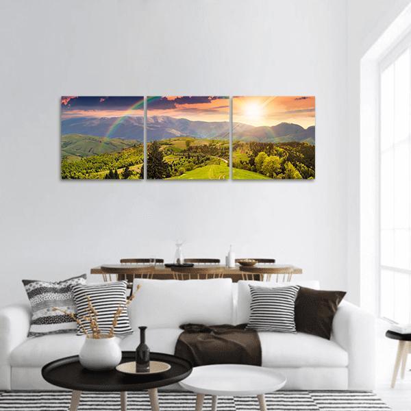 Pine Trees on Hillside at Sunset Panoramic Canvas Wall Art in orange, yellow and green, hung on a wall