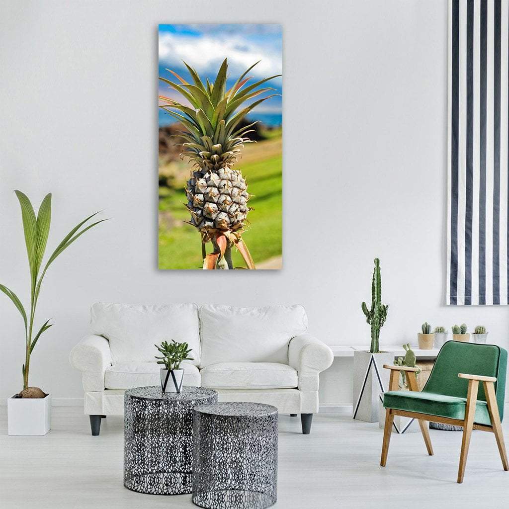 Tropical Pineapple by the Ocean Vertical Canvas Wall Art in yellow, green and blue, single vertical panel hung on a wall