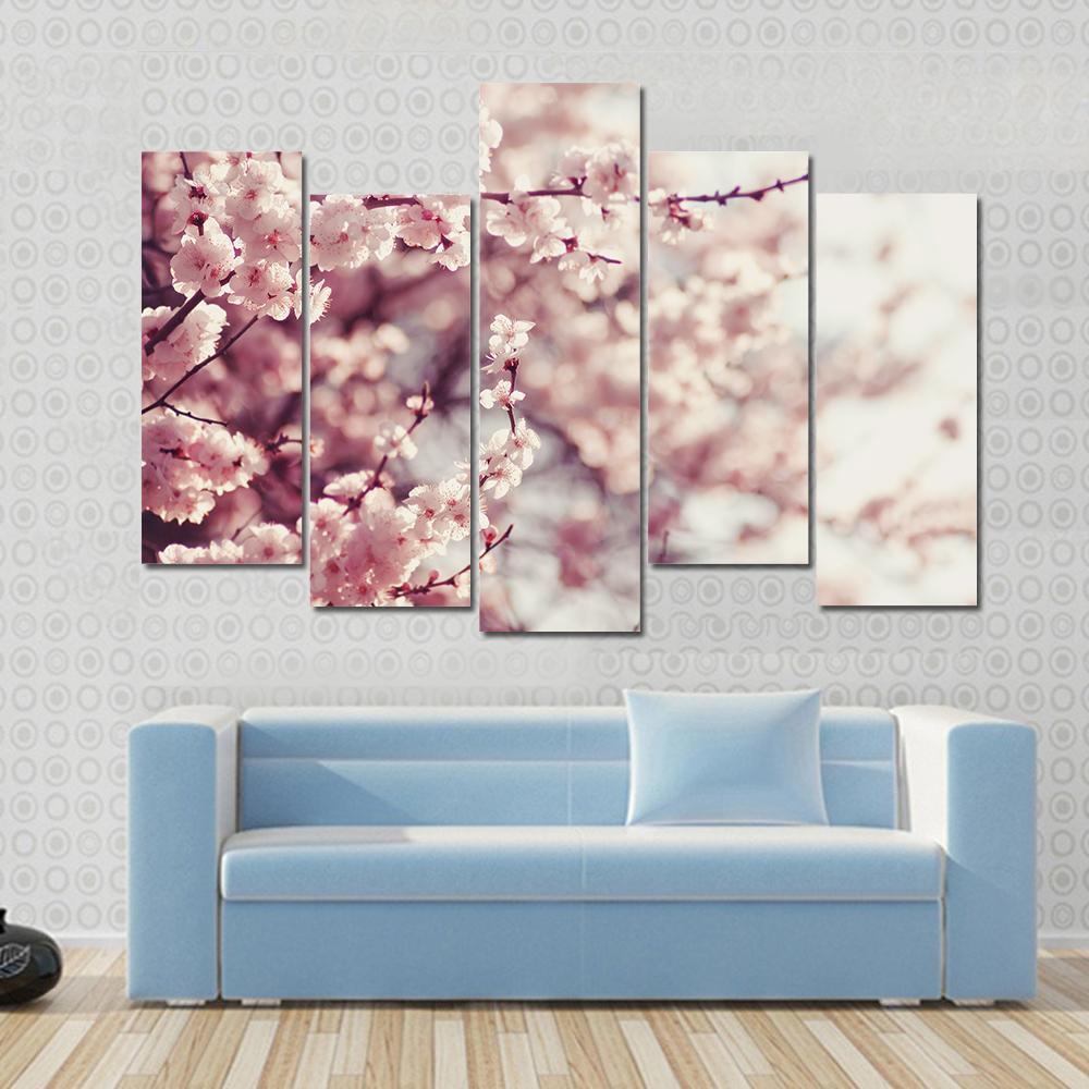 Pink Cherry Blossoms Flowers Canvas Wall Art in white and pink, 3 panel horizontal set hung on a wall
