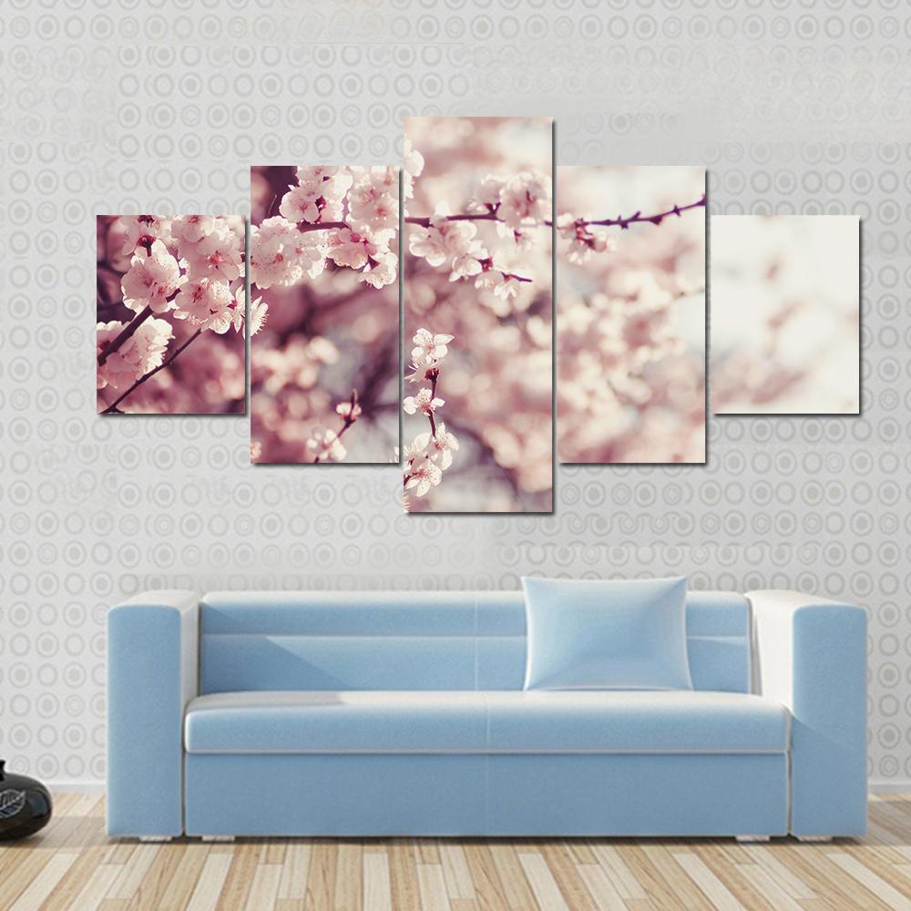 Pink Cherry Blossoms Flowers Canvas Wall Art in white and pink, 3 panel horizontal set hung on a wall
