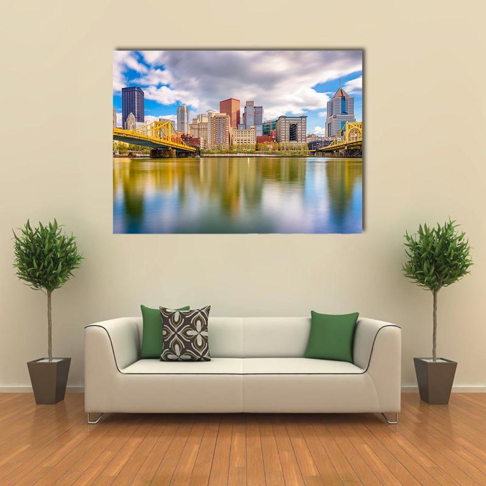 Pittsburgh Skyline Canvas Wall Art in gray, yellow and blue, single panel hung on a wall