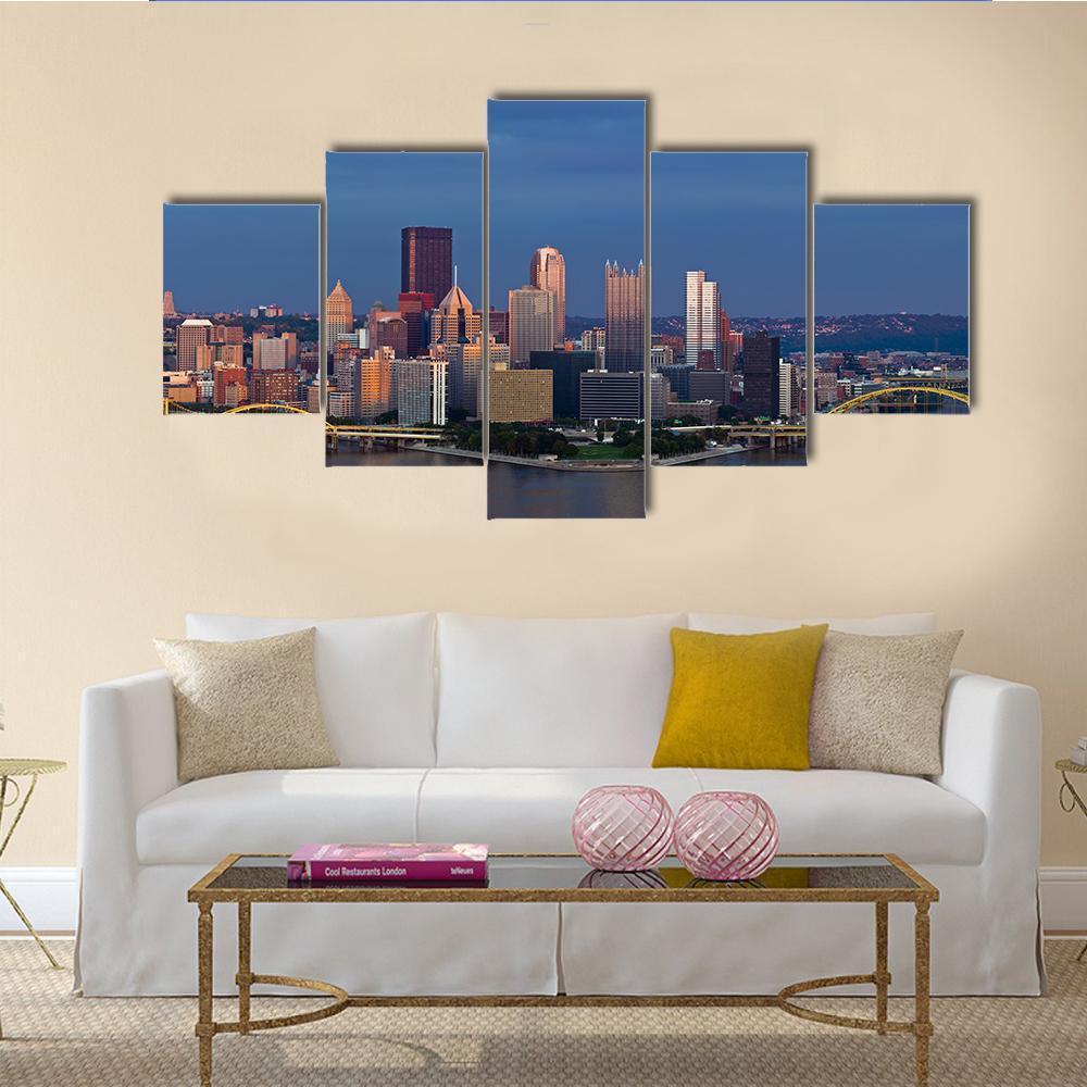 Pittsburgh Skyline at Sunset Canvas Wall Art in brown, orange and blue, 5 panel Star layout hung on a wall