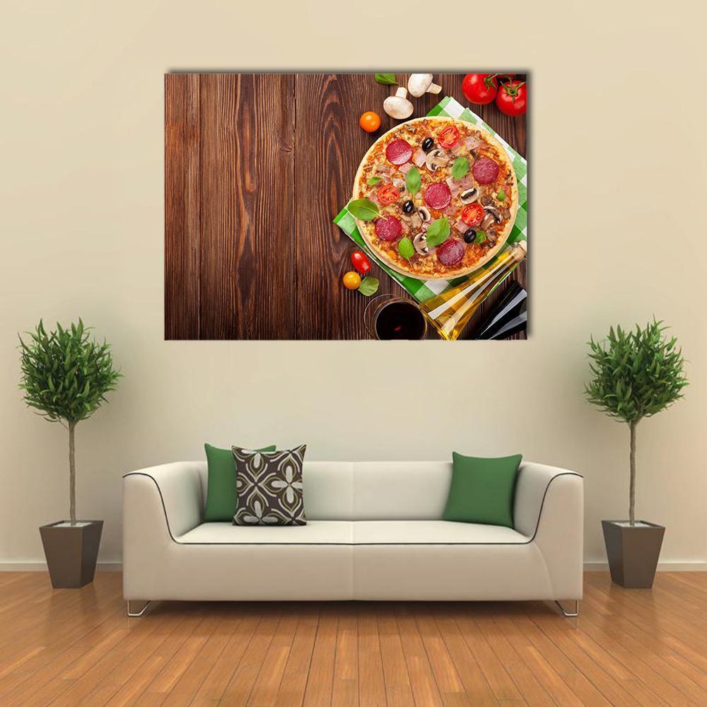 Pizza on Wooden Table Canvas Wall Art in brown, red and green, single panel hung on a wall