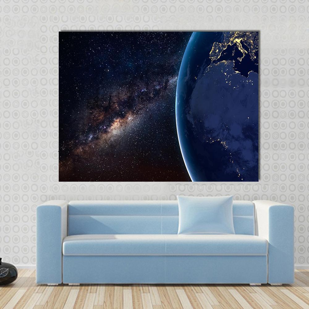 Planet Earth and Milky Way at Night Canvas Wall Art in black, blue and navy, single panel hung on a wall