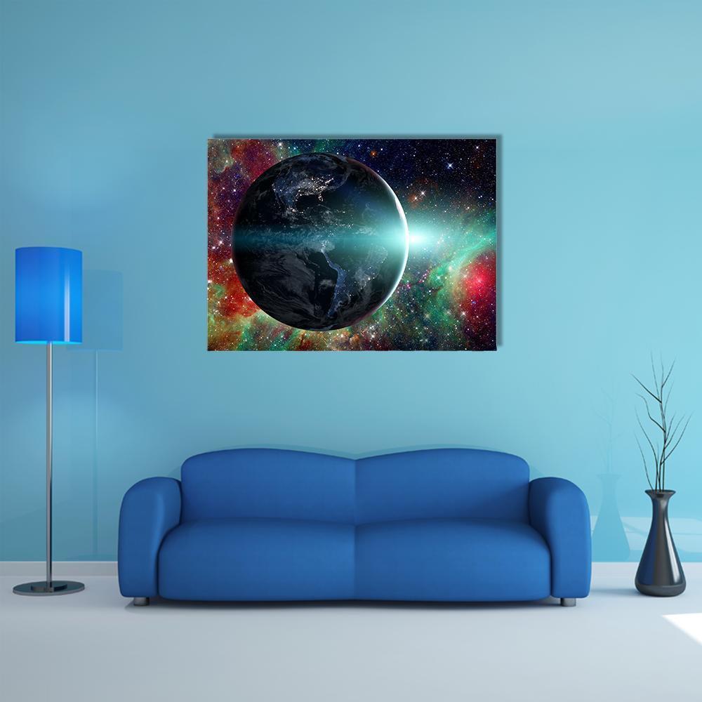 Illuminated Earth with Colorful Nebula Canvas Wall Art in black, blue and multicolor, single panel hung on a wall