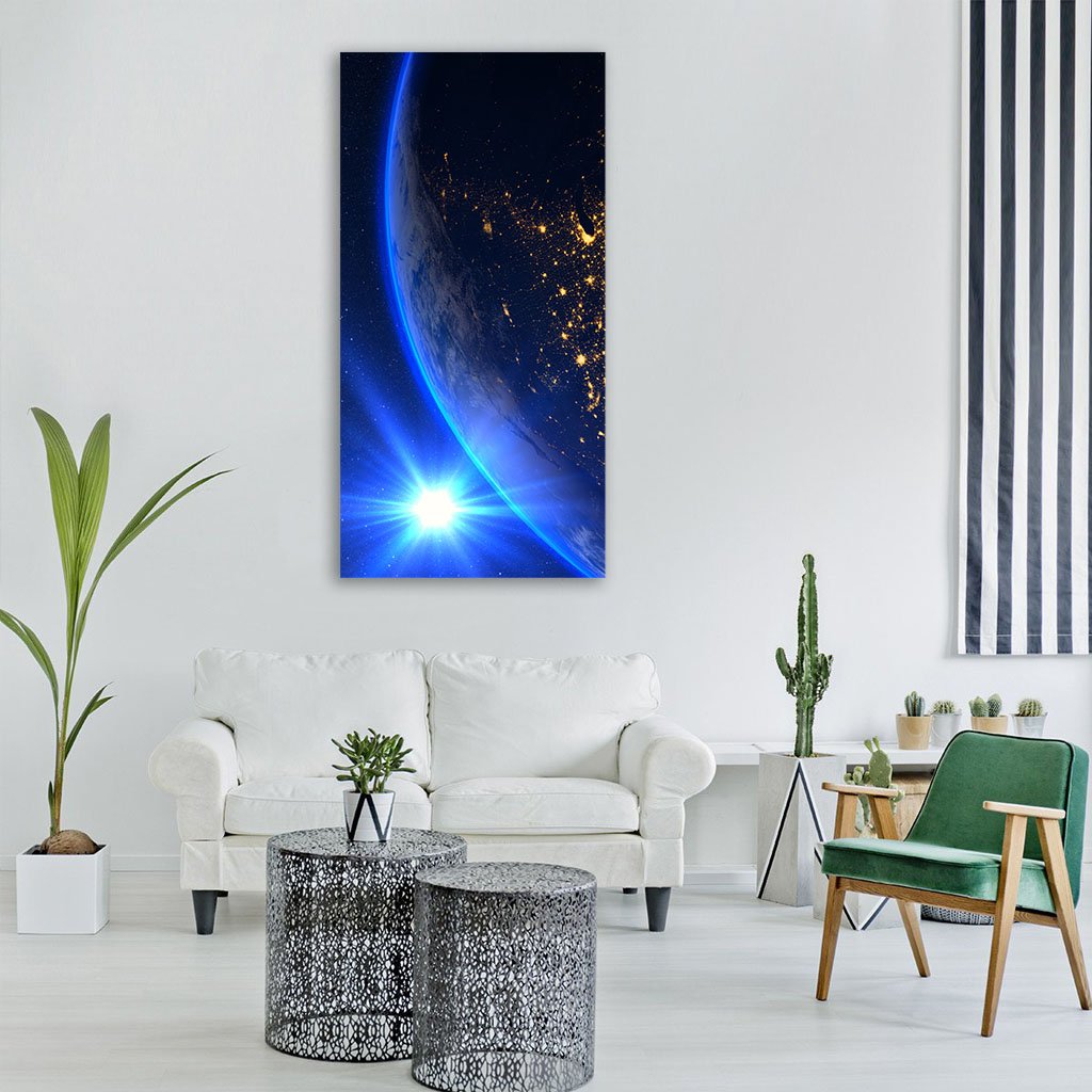 Earth from Orbit at Dawn Vertical Canvas Wall Art in black and blue, single vertical panel hung on a wall