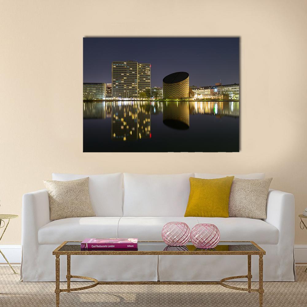 Copenhagen Skyline at Night Canvas Wall Art in black, yellow and blue, single panel hung on a wall