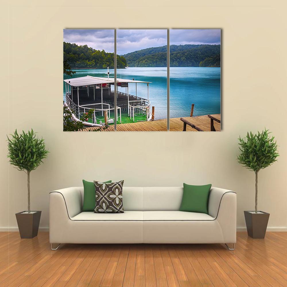 Lakeside Boat at Plitvice, Croatia Canvas Wall Art in brown, green and blue, 3 panel horizontal set hung on a wall