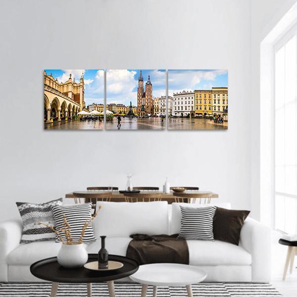 Krakow Town Square with St. Mary's Basilica Panoramic Canvas Wall Art in beige, yellow and blue, hung on a wall