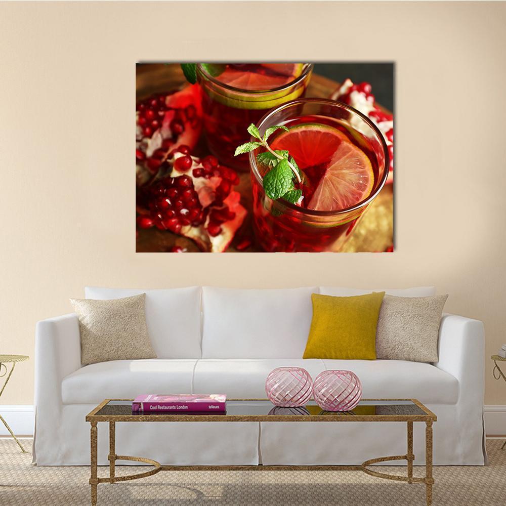 Pomegranate Drink in Glasses Canvas Wall Art in brown, red and green, single panel hung on a wall