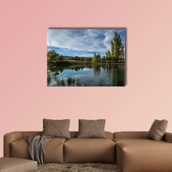 Pond in Arizona Desert Canvas Wall Art in brown, green and blue, single panel hung on a wall