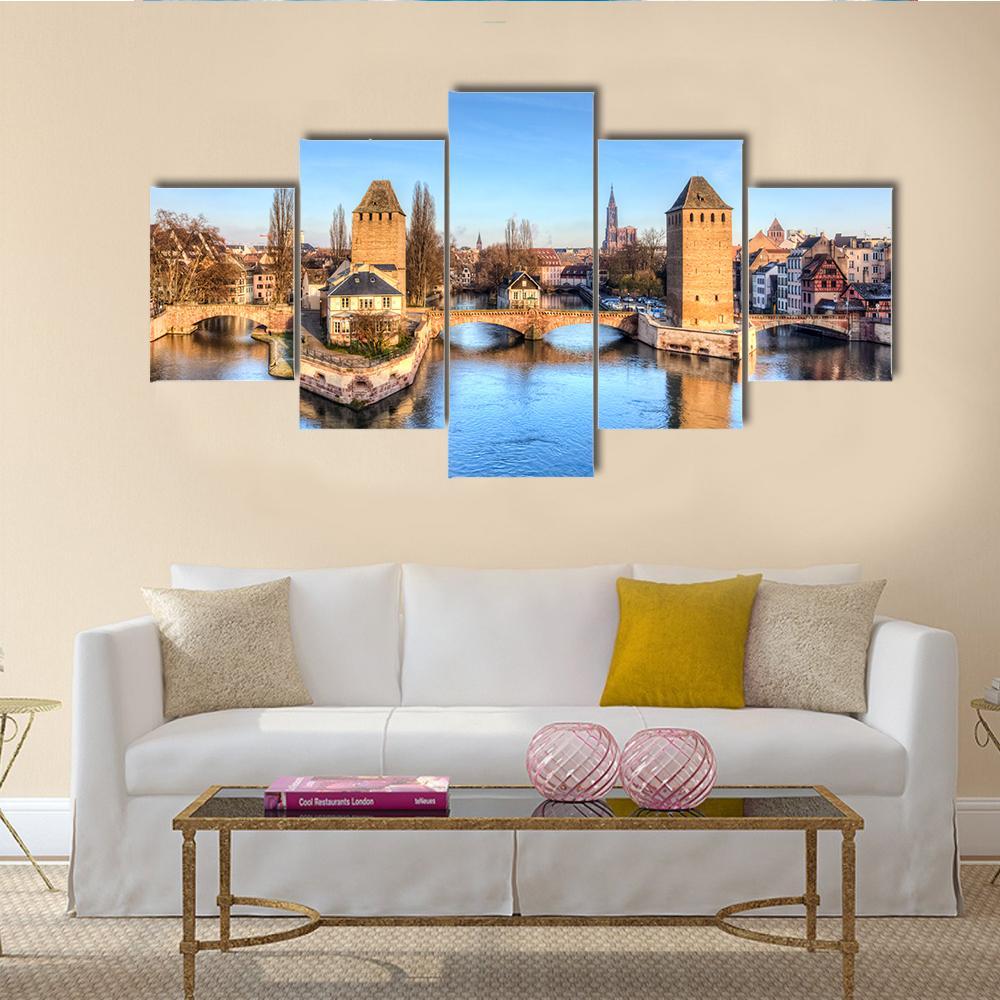 Ponts Couverts Strasbourg Bridge and River Canvas Wall Art in beige, brown and blue, 5 panel Star layout hung on a wall