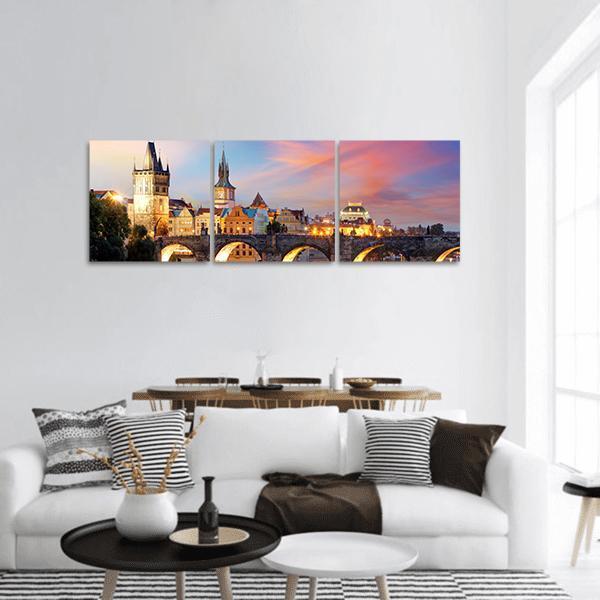 Charles Bridge at Night Panoramic Canvas Wall Art in orange, yellow and blue, hung on a wall