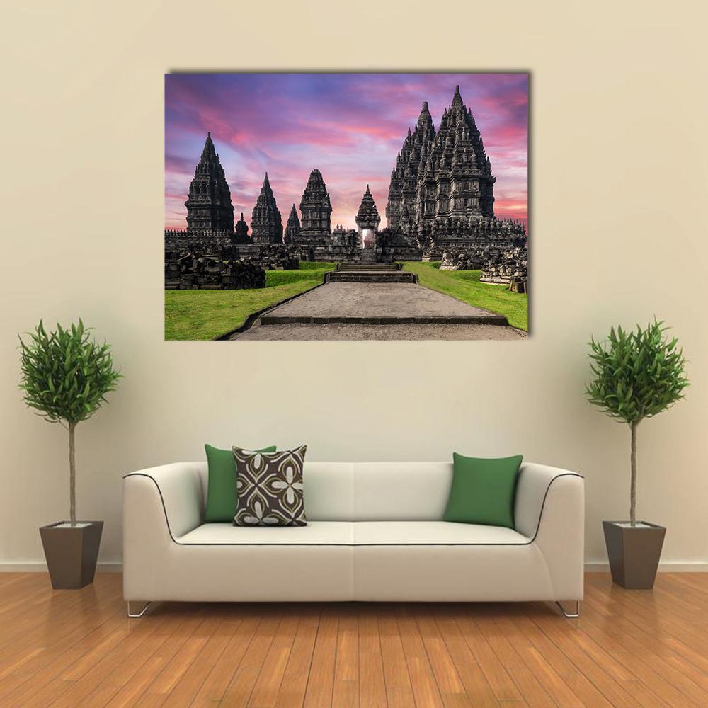 Prambanan Temple at Sunrise Canvas Wall Art in green, purple and pink, single panel hung on a wall