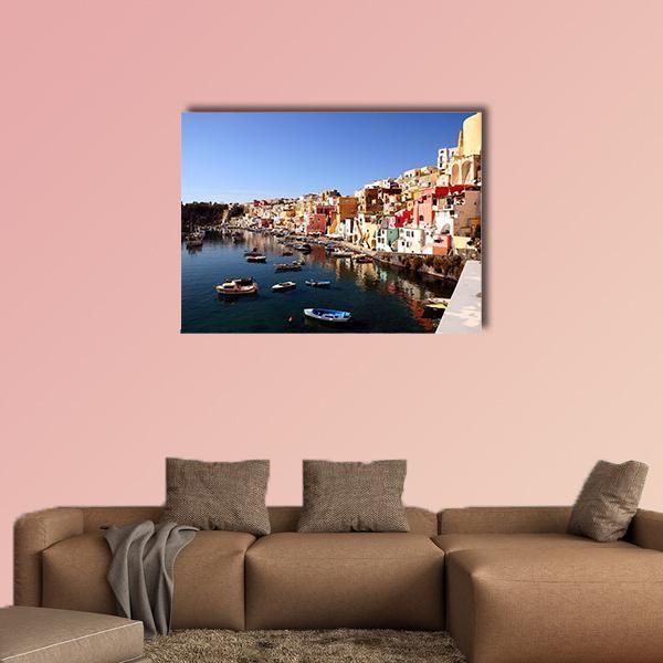 Procida Island Harbor with Colorful Buildings Canvas Wall Art in blue and multicolor, single panel hung on a wall