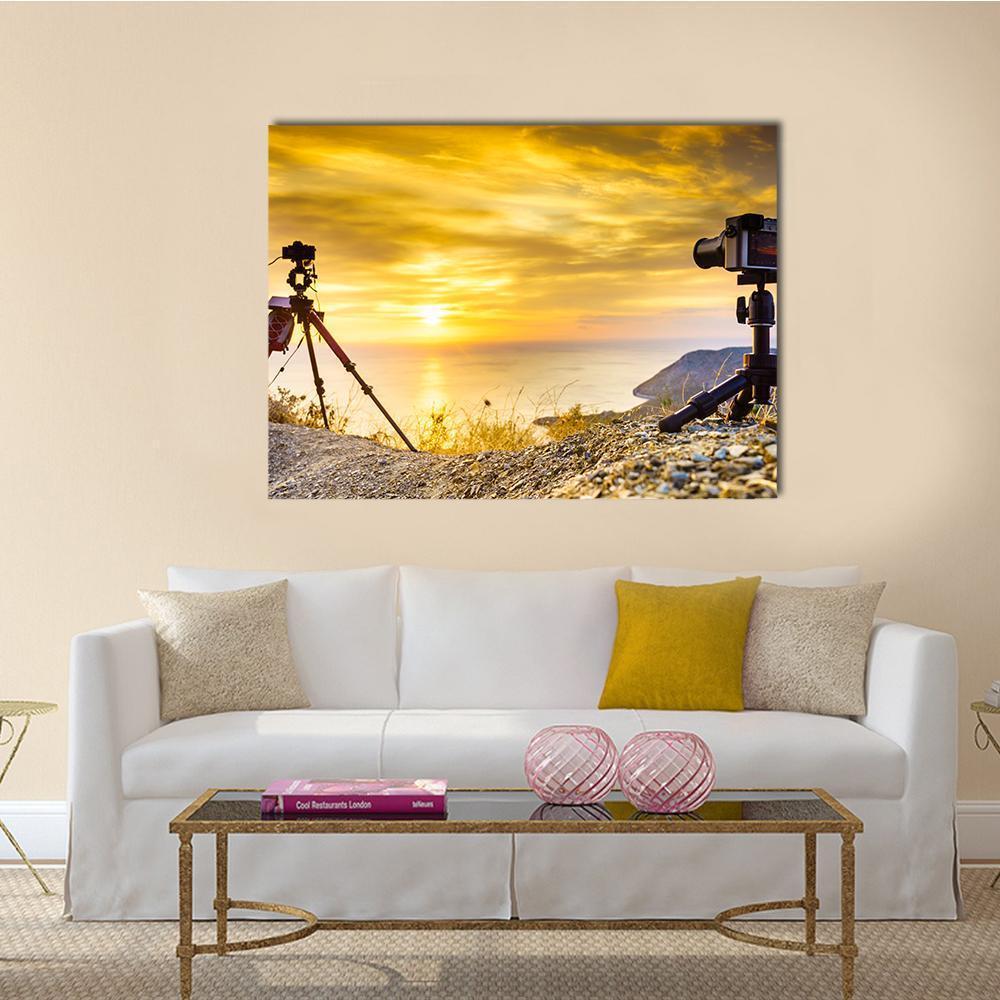 Two Cameras Overlooking Ocean at Sunset Canvas Wall Art in gold, orange and yellow, single panel hung on a wall
