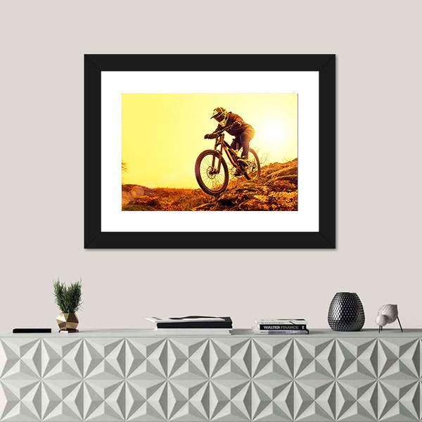 Cyclist Riding Mountain Bike Canvas Wall Art in brown, orange and yellow, framed print, product view on a white background